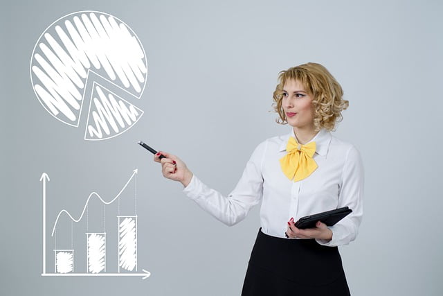 A smartly dressed business woman points at some graphs.