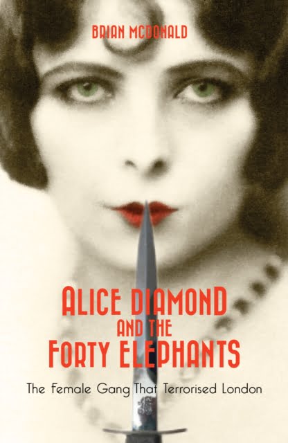 Book cover. A woman with a short bobbed haircut is holding a dagger to her red lips.
